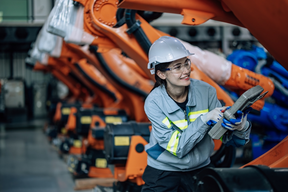 Robotic,Technician,Uses,Control,Panel,To,Operate,,Maintain,Robotic,Arm